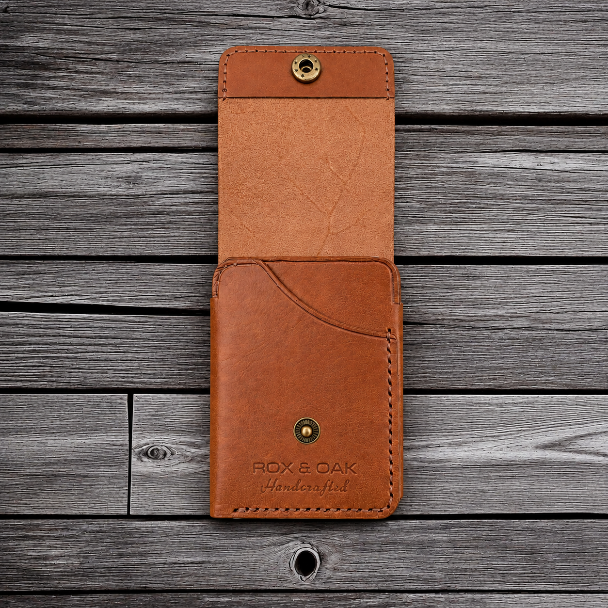 Open Rox & Oak slim leather wallet placed on rustic wooden background.