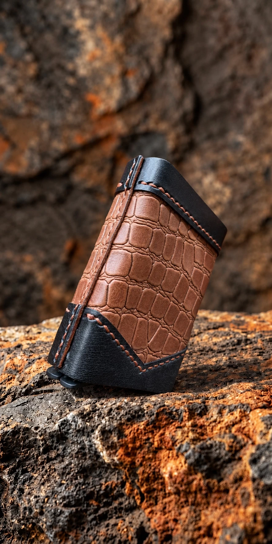 ROX & OAK TwinSlide brown and black leather card holder displayed on natural rock