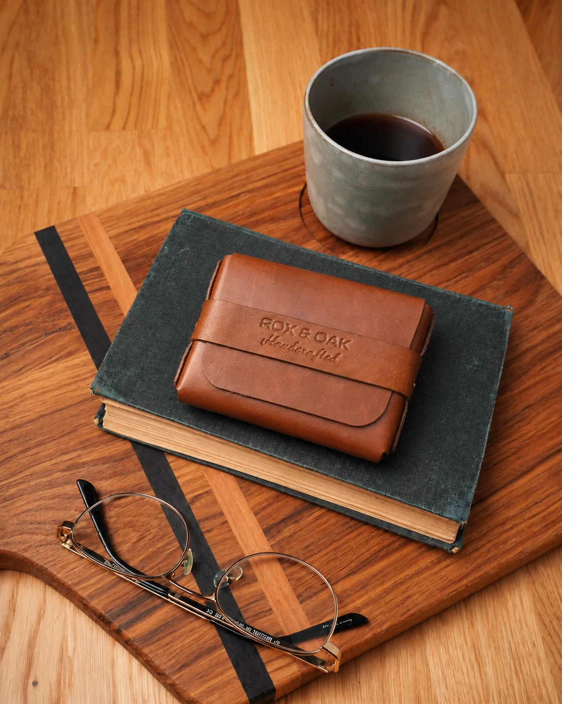 Oaklet chestnut brown leather card holder wallet placed on a notebook beside a coffee cup Copy alt text